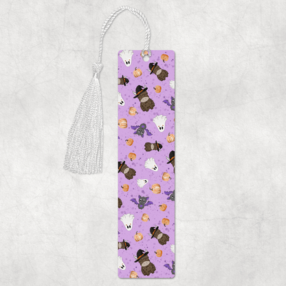 Purple bookmark with cartoon animal designs on a light gray background halloween highland cow theme