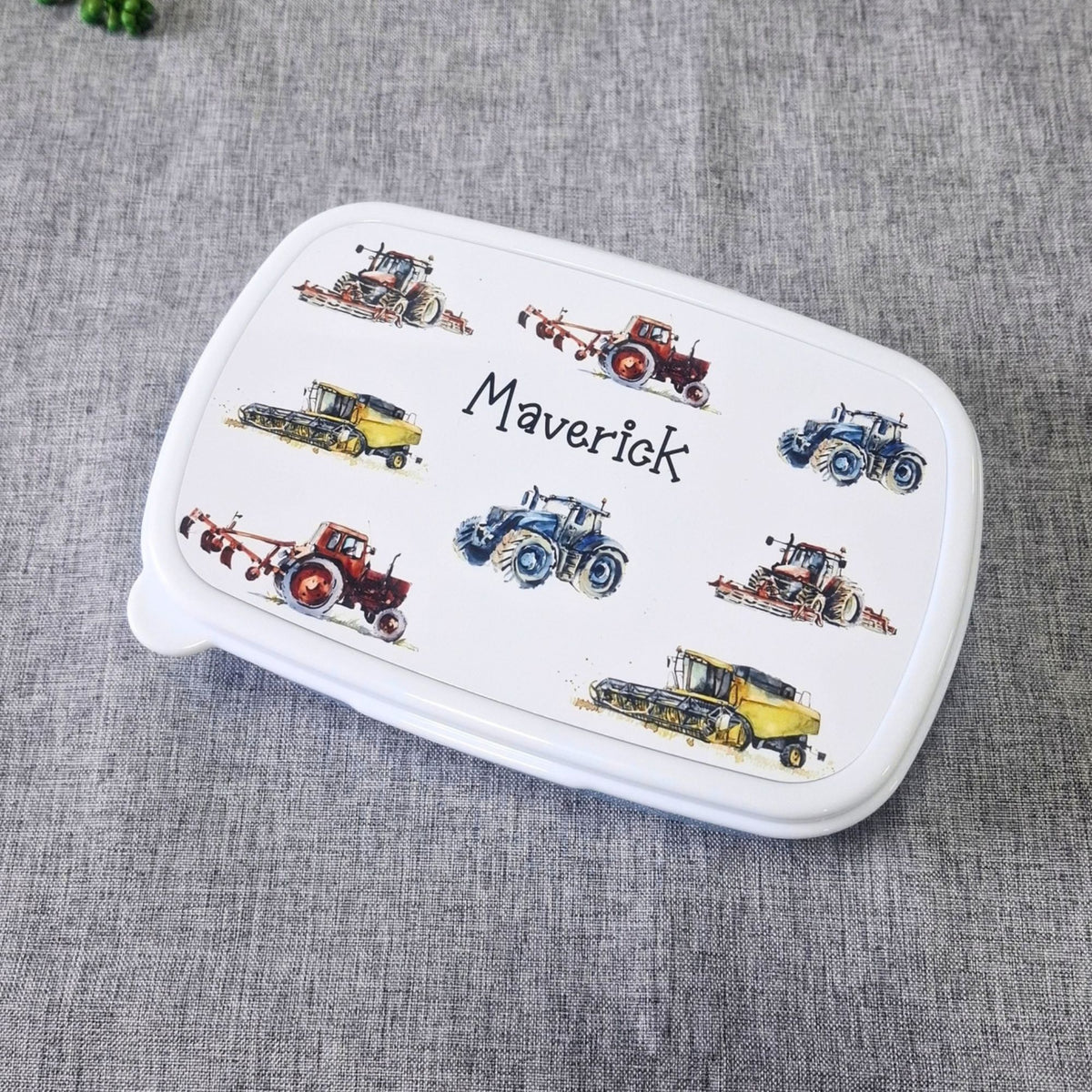 Personalised tractor snack box with colourful tractors and the name Maverick