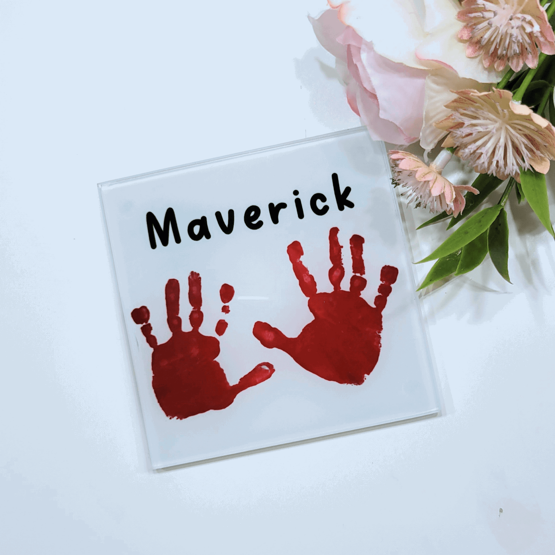 Childs handprint printed on to a glass square coaster