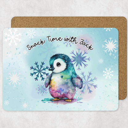 Colourful penguin placemat with snowflakes and 'Snack Time with Jack' text on a light blue background.