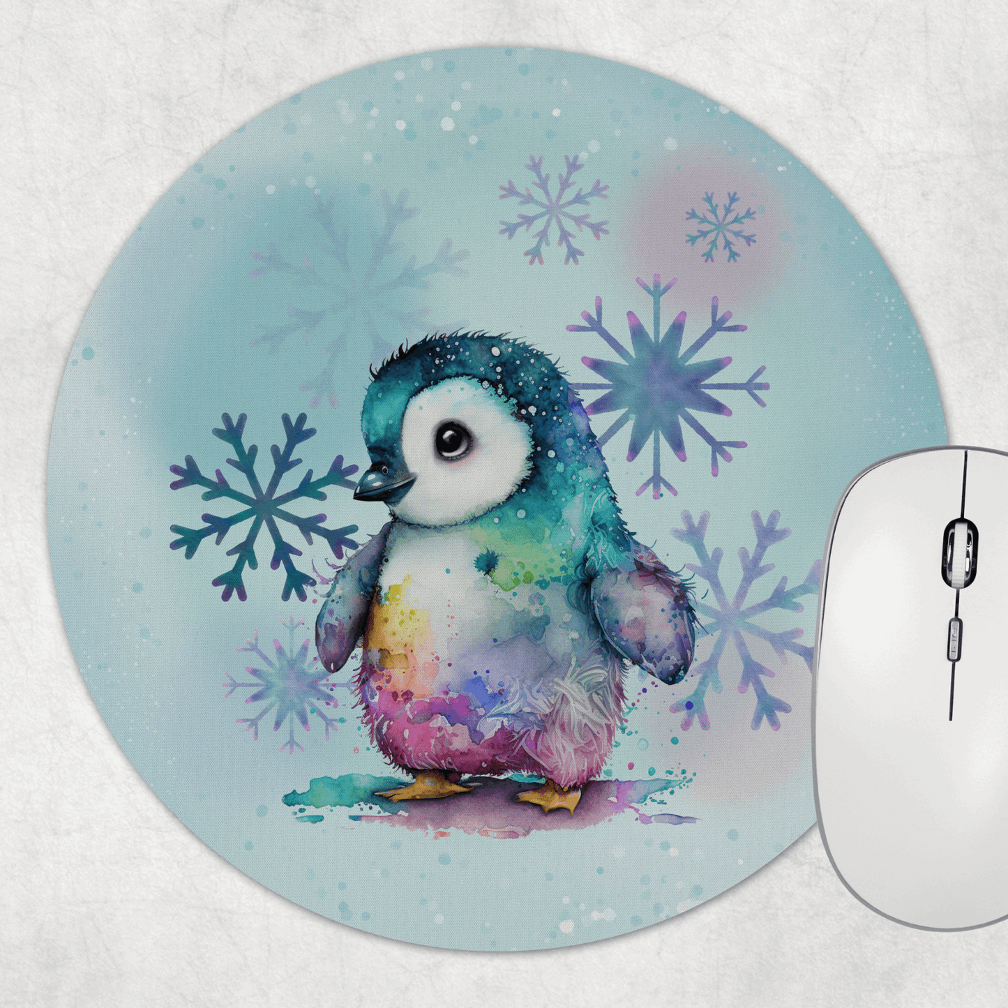 Round mouse pad with a colorful penguin design on a light blue background, next to a wireless mouse.